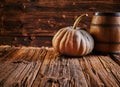 Pumpkin and barrel on old wooden table Royalty Free Stock Photo