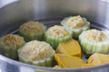 Pumpkin and bitter melon stuffed with vermicelli, tofu, corn and carrot while steaming in steaming pot Royalty Free Stock Photo