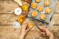 Pumpkin buns or biscuits, traditional fall baked goods. Female hands hold cookies