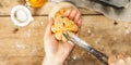 Pumpkin buns or biscuits, traditional fall baked goods. Female hands hold cookies