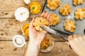 Pumpkin buns or biscuits, traditional fall baked goods. Female hands hold cookies