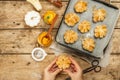 Pumpkin buns or biscuits, traditional fall baked goods. Female hands hold cookies