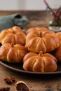 Pumpkin buns bread with spices on brown background. Halloween Food Concept. Autumn concept. Royalty Free Stock Photo