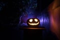 Pumpkin Burning In Forest At Night - Halloween Background. Scary Jack o Lantern smiling and glowing pumpkin with dark toned foggy Royalty Free Stock Photo