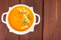 Pumpkin carrot cream soup with parmesan and green shoots of watercress Royalty Free Stock Photo