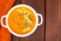 Pumpkin carrot cream soup with parmesan and green shoots of watercress Royalty Free Stock Photo