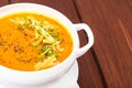 Pumpkin carrot cream soup with parmesan and green shoots of watercress Royalty Free Stock Photo