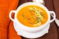 Pumpkin carrot cream soup with parmesan and green shoots of watercress Royalty Free Stock Photo