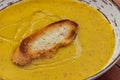 Pumpkin and carrot cream soup with piece of toasted bread. Autumn cream-soup in country style. Royalty Free Stock Photo