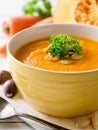 Pumpkin and carrot cream soup with pumpkin seeds and parsley in bowl on white wooden background. Royalty Free Stock Photo