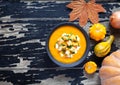 Pumpkin and carrot soup with cream, croutons, on creative dark background for Thanksgiving, halloween. Top view Royalty Free Stock Photo