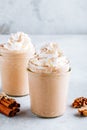 Pumpkin and carrot spice latte with whipped cream and cinnamon in glass jars Royalty Free Stock Photo