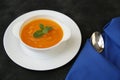 Pumpkin or carrot or sweet potato soup puree in a bowl on a black background with spoon. Copy space. Isolated. Food background Royalty Free Stock Photo