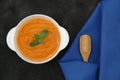 Pumpkin or carrot or sweet potato soup puree in a bowl on a black background with spoon. Copy space. Isolated. Food background Royalty Free Stock Photo