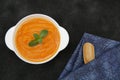 Pumpkin or carrot or sweet potato soup puree in a bowl on a black background with spoon. Copy space. Isolated. Food background Royalty Free Stock Photo