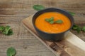 Pumpkin or carrot or sweet potato soup puree in a bowl on a wooden background with spoon. Copy space. Isolated. Food background Royalty Free Stock Photo