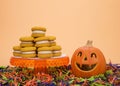 Pumpkin cookie sandwiches on a pedestal with jack o lantern