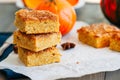 Pumpkin cornmeal bars with spices on a wooden background. Close