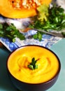 Pumpkin cream soup in bowl with parsley Royalty Free Stock Photo