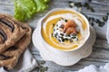 Pumpkin cream soup with cream and shrimp. tasty and healthy food for dinner. copy space Royalty Free Stock Photo