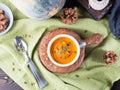 Pumpkin cream soup in green mugs. Rustic style