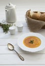 Pumpkin cream soup puree on a light wooden table in a white plate. Selective focus Royalty Free Stock Photo