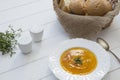 Pumpkin cream soup puree on a light wooden table in a white plate. Selective focus Royalty Free Stock Photo