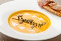 Pumpkin cream soup purÃÂ©e with bread slice, bacon and seeds