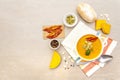 Pumpkin cream soup. White ceramic bowl with fresh pumpkin, dry pumpkin seeds, smoked bacon and bun roll. With vintage linen Royalty Free Stock Photo