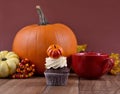 Halloween cupcake with pumpkin on a wooden background stock images