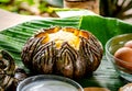 Pumpkin custard in pumpkin fruit cooking with hot steaming, Thai dessert menu served on the table in the garden at home. Royalty Free Stock Photo