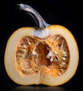 Pumpkin cut in half against black background Royalty Free Stock Photo