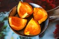 Pumpkin cut into quarters in a pan