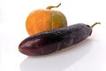 Pumpkin and eggplant on white background with water droplets.