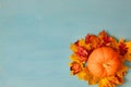 Pumpkin and fall leaves on a blue wooden background. Thanksgiving and Halloween concept. View from above. Top view. Copy Royalty Free Stock Photo