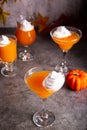 Pumpkin fall seasonal drink cocktail latte with spices and whipped cream for Thanksgiving or Halloween party festive celebrate. Royalty Free Stock Photo