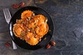 Pumpkin filled ravioli pasta. Overhead view on a dark slate background. Royalty Free Stock Photo