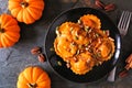 Pumpkin filled ravioli pasta. Above table scene on a dark background.