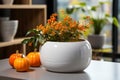 Pumpkin and flowers in white vase on table in room