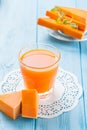 Pumpkin fresh juice in beautiful glasses and jug with pieces of ripe vegetable on white wooden background. Sweet orange juice. Hea Royalty Free Stock Photo