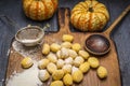 Pumpkin gnocchi Ingredients for cooking strainer spoon flour on ÃÂutting board on dark rustic background close up Royalty Free Stock Photo