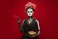 Young girl in the image of Santa Muerte, Saint death or Sugar skull with bright make-up. Portrait isolated on studio Royalty Free Stock Photo