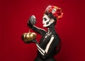 Young girl in the image of Santa Muerte, Saint death or Sugar skull with bright make-up. Portrait isolated on studio Royalty Free Stock Photo