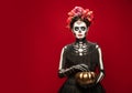 Young girl in the image of Santa Muerte, Saint death or Sugar skull with bright make-up. Portrait isolated on studio Royalty Free Stock Photo