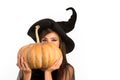 Pumpkin head jack lantern. Trick or treat. Woman posing with Pumpkin. Beautiful young surprised woman in witches hat and Royalty Free Stock Photo