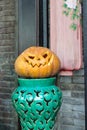 Pumpkin head smiling on a green vase