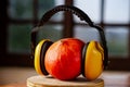 Pumpkin with headphones on wooden background. Headphones anti-noise worn on pumpkin. When you don\'t want to hear sounds Royalty Free Stock Photo