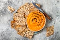 Pumpkin hummus seasoned with olive oil and black sesame seeds with whole grain crackers. Healthy vegetarian appetizer or snack. Royalty Free Stock Photo