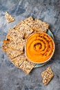 Pumpkin hummus seasoned with olive oil and black sesame seeds with whole grain crackers. Healthy vegetarian appetizer or snack. Royalty Free Stock Photo