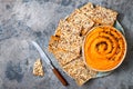 Pumpkin hummus seasoned with olive oil and black sesame seeds with whole grain crackers. Healthy vegetarian appetizer or snack. Royalty Free Stock Photo